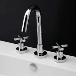 Lacava 1582-CR Cigno Deck-mount Three-hole Faucet With A Goose-neck Swiveling Spout, Two Cross Handles, And A Pop-up Drain. Water Flow Rate: 1 Gpm Pressure Compensating Aerator. In Polished Chrome